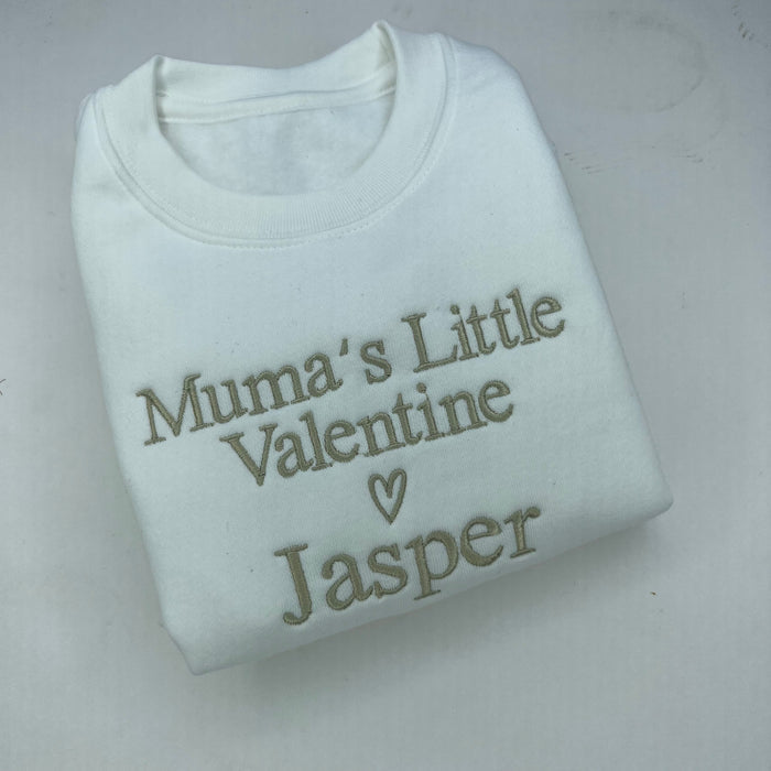White sweatshirt with 'Mum's Little Valentine Jasper' text on a light gray background