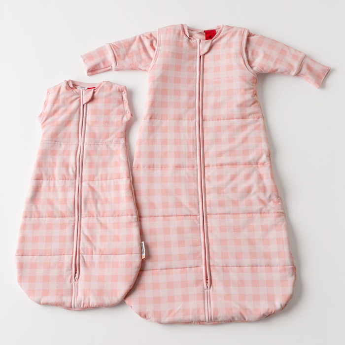Pink gingham newborn swaddle sack and infant sleep sack laid flat — Newborn to Infant Sleep Sack Bundle