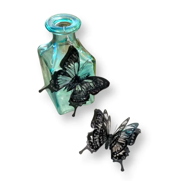 Oversized black butterfly dangling earrings with 3D layered wings in black and clear plastic – statement fairycore and Halloween jewelry