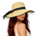Model wearing the Beige Oversized Wide Linen Bow Straw Hat for beach and resort sun protection