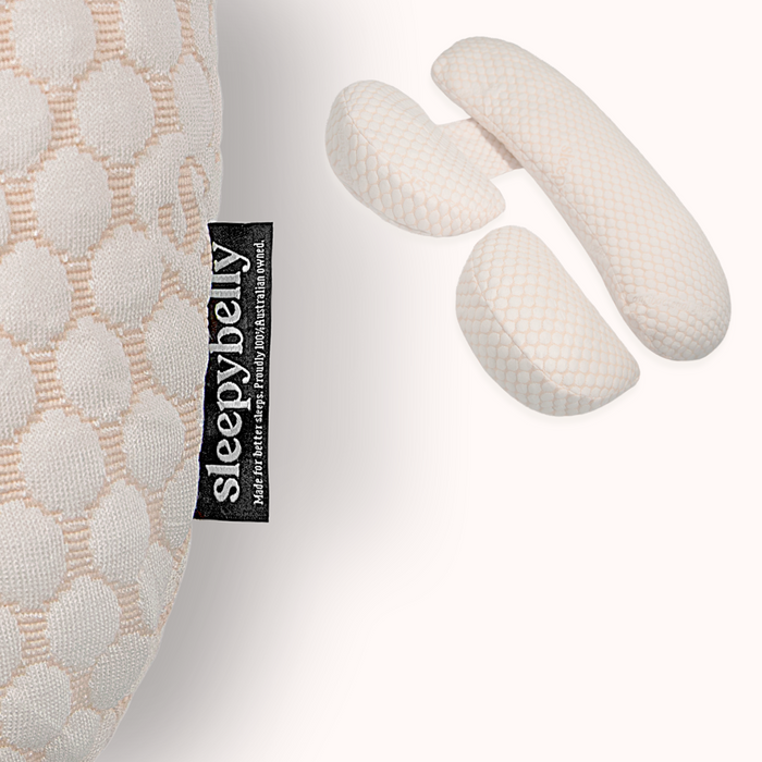 Blush textured pregnancy pillow cover with Sleepybelly label, shown with the three-piece Pillow Bundle set