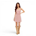 Pink Corduroy Summer Mini Dress with V-neckline, smocked back, adjustable straps, and asymmetric button detail woman wearing with cowboy boots