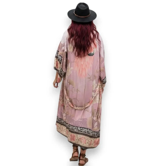 women's wearing wide brim hat with pink flamingo print kimono beach cover up with floral design and sash / one size fits most