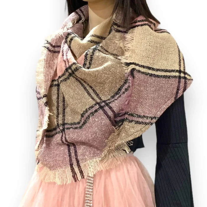 woman wearing a multicolor plaid triangle neck wrap scarf with fringe, styled as a cozy layered shawl
