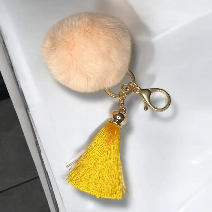 women's Plush Pink Fur Ball Tassel Handbag Charm with gold clasp and orange tassel one size