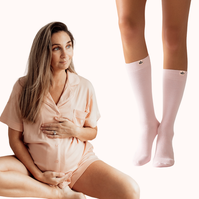 Rest & Recover Bundle: mum-to-be in peach maternity pyjamas with pale pink maternity compression socks