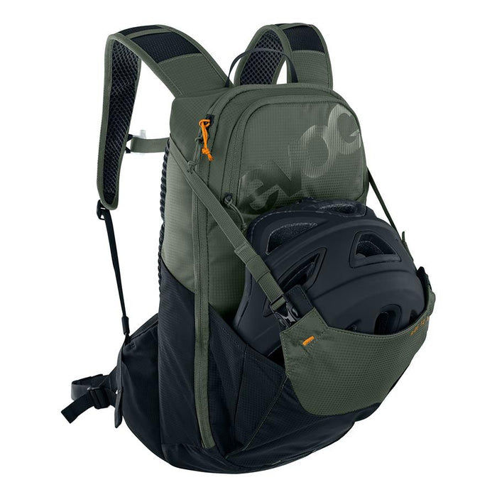Green and black backpack with a helmet inside on a white background
