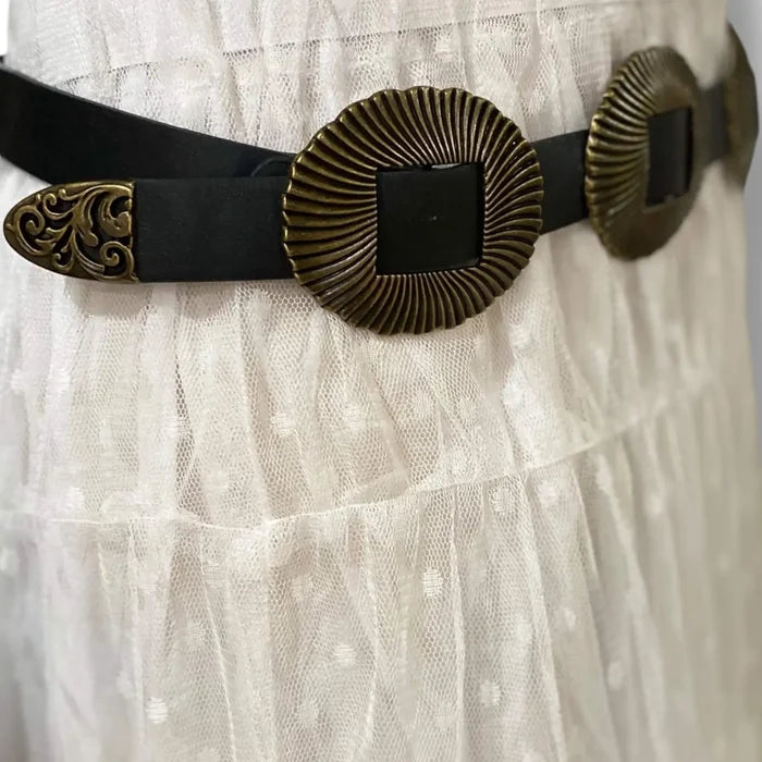 detail of ridged shell textured buckles antique gold finish filagree belt tip