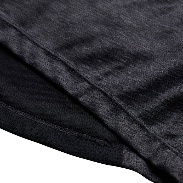 Close-up of black and gray fabric with a visible seam on a white background