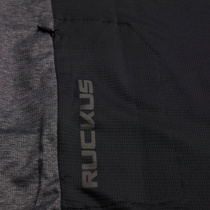 Close-up of a black fabric with 'Ruckus' branding on a gray background
