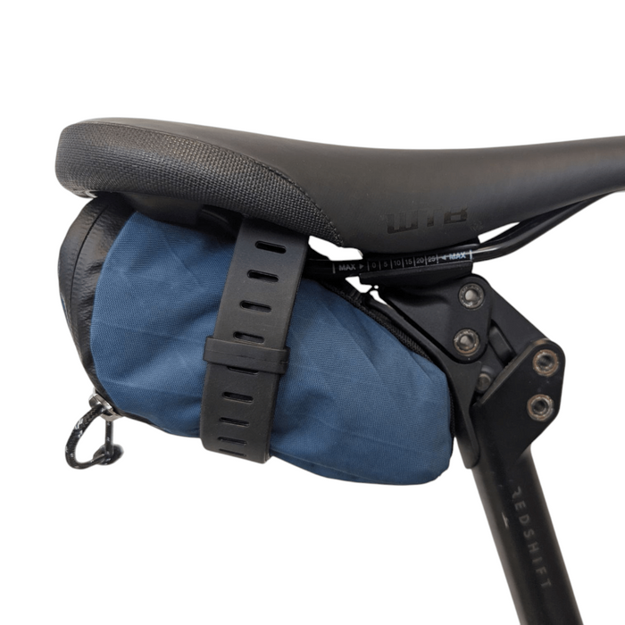 Bicycle saddle bag attached to a bike seat with a white background
