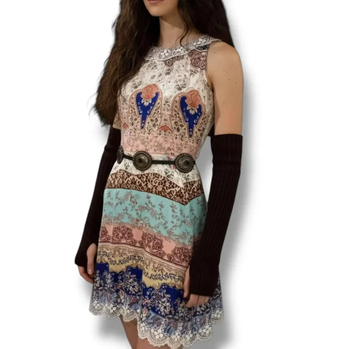Elegant sleeveless patchwork mini dress with ivory embroidered round neckline, sheer lace back panel, and lace-trim hem in multicolor boho print
