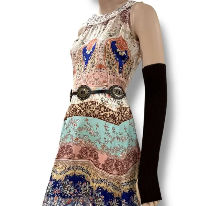 Elegant sleeveless patchwork mini dress with ivory embroidered round neckline, sheer lace back panel, and lace-trim hem in multicolor boho print