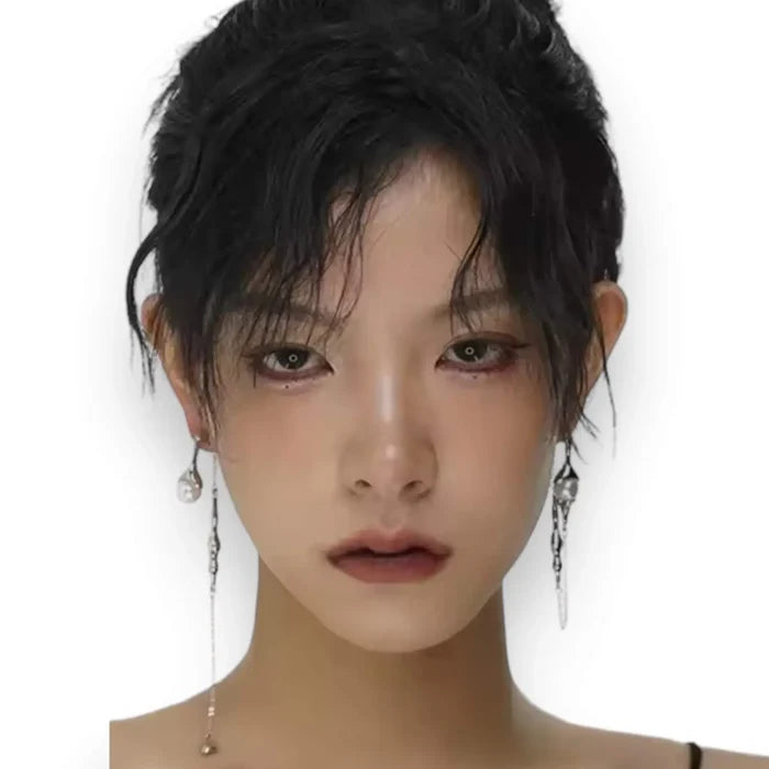 Silver asymmetrical pearl drop earrings with silver curb chains, simulated white pearls, and crystal accents, modern gothic and Y2K fashion jewelry.