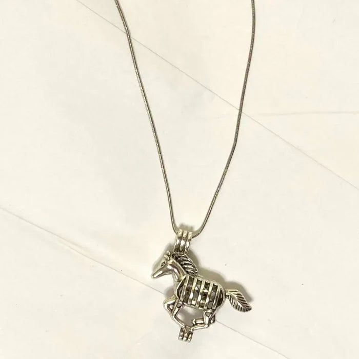 Silver horse pendant long necklace with glow-in-the-dark bead and essential oil lava stone on 28-inch snake chain in boho western style