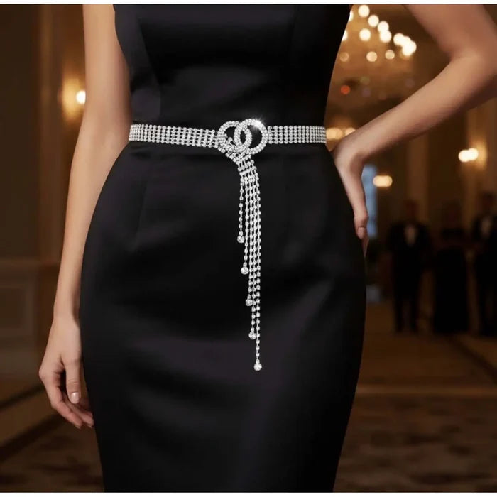 Woman wearing silver sparkle rhinestone fringe chain belt double O-ring buckle waterfall tassel, adjustable hook closure, waist statement belt.