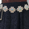 Silver turquoise cross western chain belt with textured cross medallion links and green faux turquoise centers, adjustable clasp closure, worn at waist or hips.