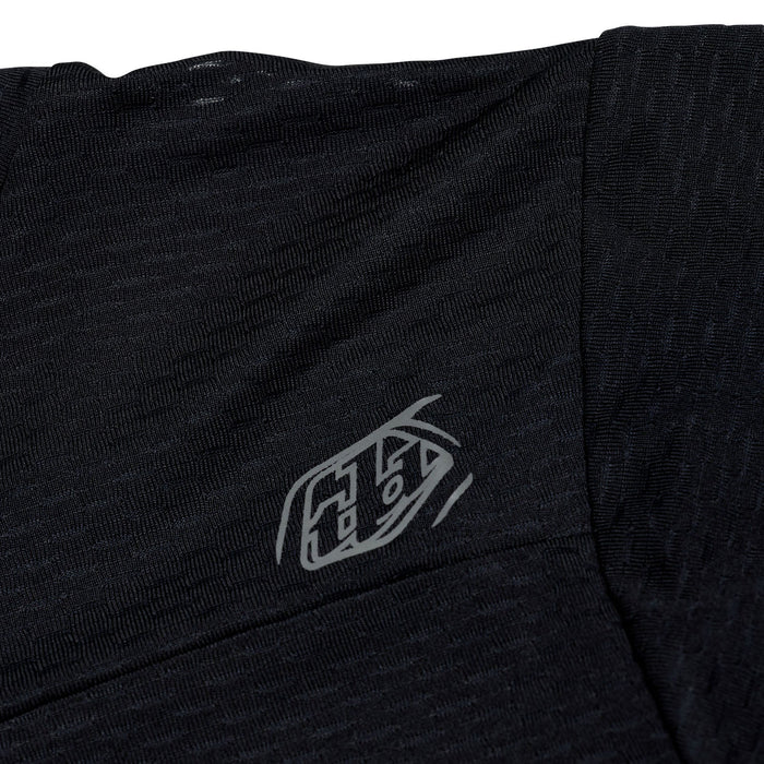 Black t-shirt with a logo on the chest against a white background