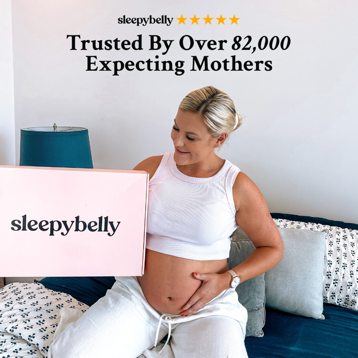 Pregnant woman holding a pink Sleepybelly box, trusted by over 82,000 expecting mothers