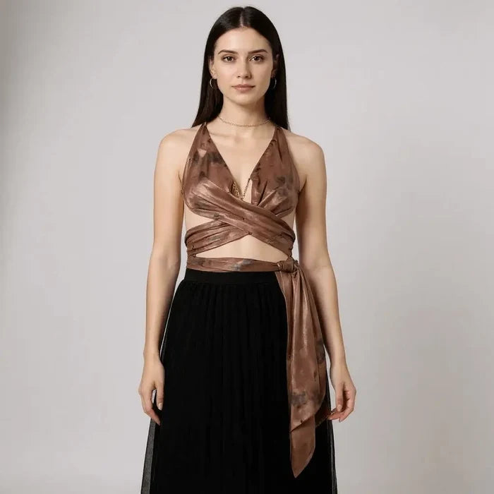 Sleeveless brown multi wrap halter top with plunging neckline, gold chain medallion, backless design, and extra-long ties styled for Y2K streetwear and festival fashion
