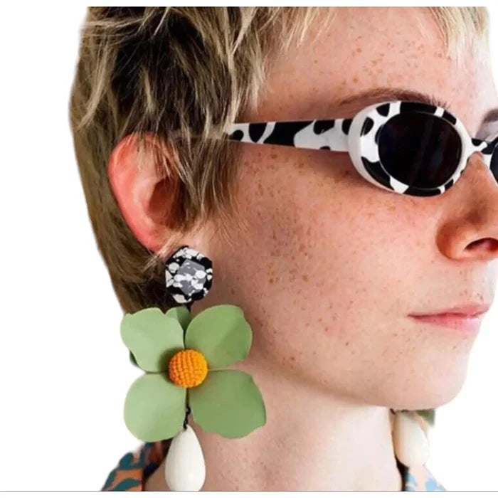 Women’s vintage-inspired oval sunglasses with black and white animal print and stylish summer look.