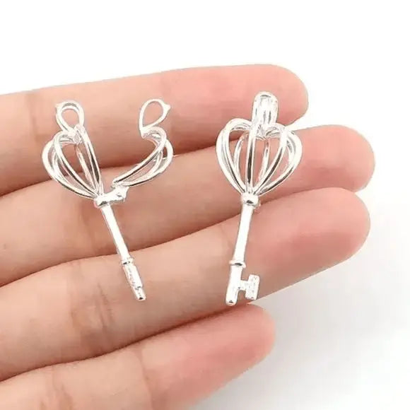Sterling silver heart crown skeleton key pendant with faux pearl on dainty chain – necklace flat lay on neutral background
