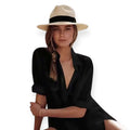 Classic summer fedora hat in natural straw with elegant black band, ideal for outdoor adventures and festivals.