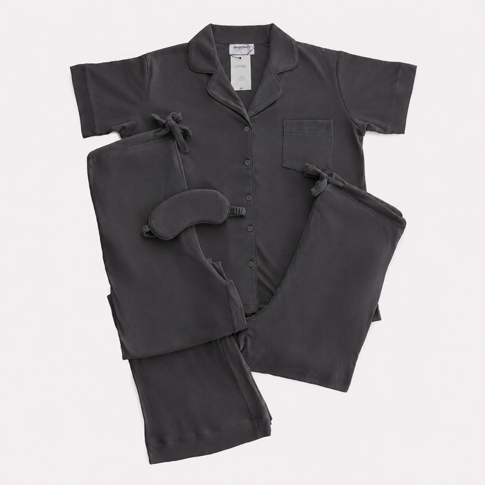 Charcoal maternity pyjama set laid flat with matching eye mask and drawstring bag from the Sleepybelly bundles
