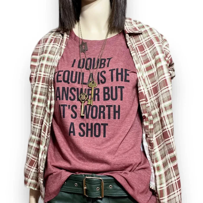Tequila short sleeve graphic tee with bold quote, styled with plaid shirt and layered necklaces.