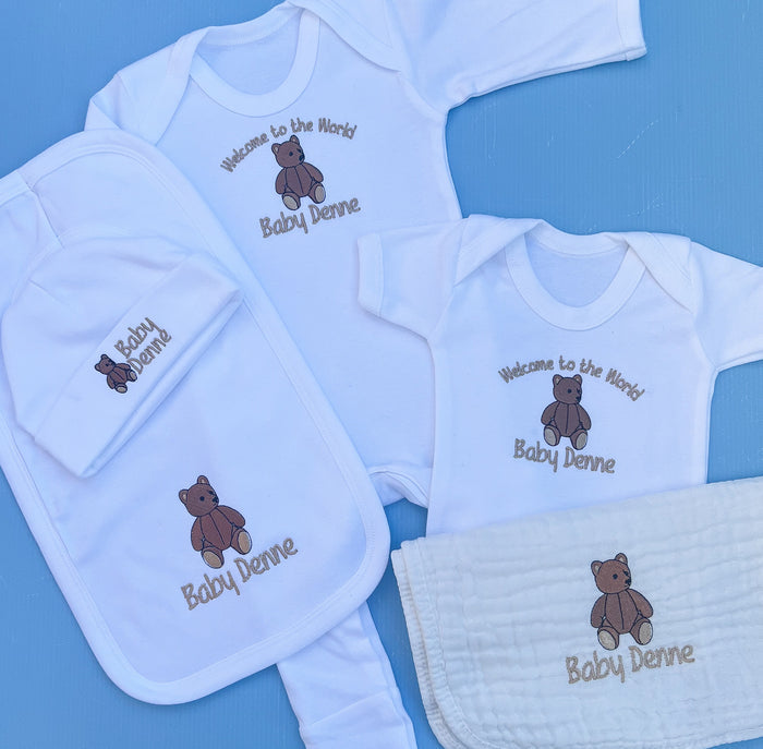 Close of of baby set with traditional bear embroidery