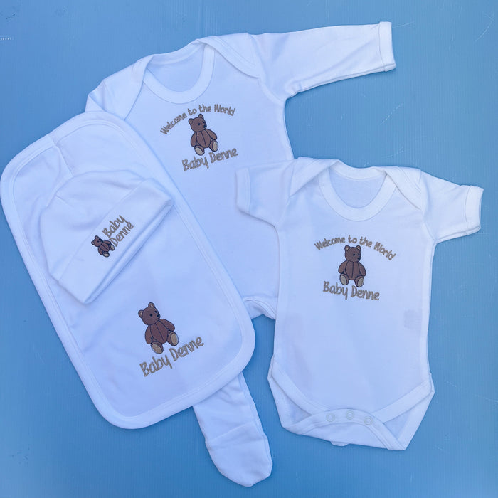Baby set with babygrow, hat, vest and bib all with a traditional bear embroidery