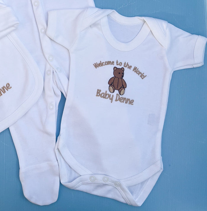 Close up of baby vest with traditional bear embroidery