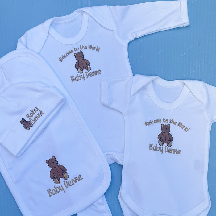 Baby set with babygrow, hat, vest and bib all with a traditional bear embroidery