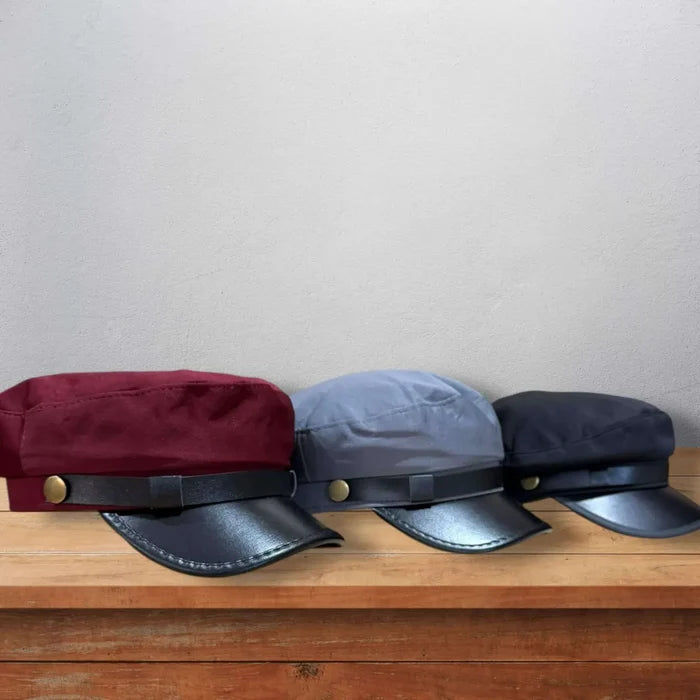 Two Tone Cotton Flat Top Fisherman Cap black faux leather curved brim, and gold button band in burgundy, gray, and black.