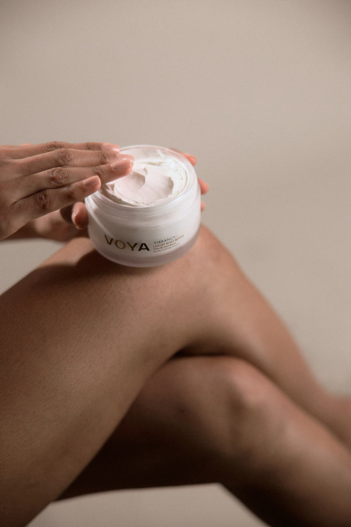 VOYA Vibrancy body butter with models hand