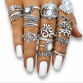 Vintage silver boho stacking rings set with 14 symbolic bands, blue faux stones and knuckle designs