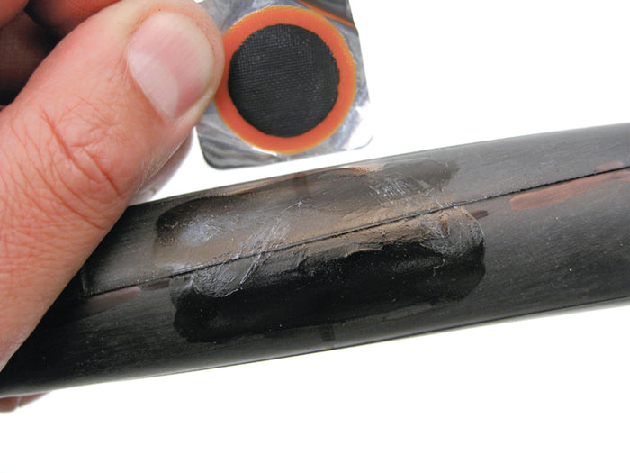 Close-up of a person holding a metal object with a worn area, showing a rubber gasket.