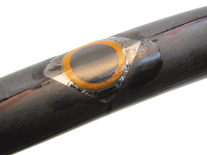 Close-up of a black object with a circular component on a white background