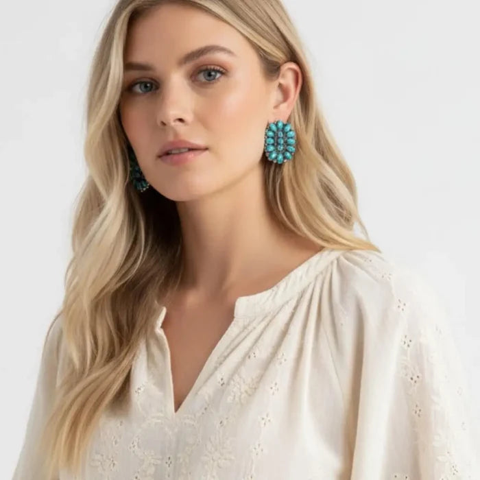 Model wearing Western Turquoise Cluster Earrings featuring turquoise-tone stones in a silver-finish design.