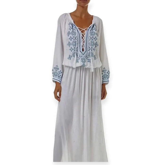 model wearing White Blue Embroidered Kaftan Dress with lace-up tassel neckline, long sleeves, smocked waist, and side splits