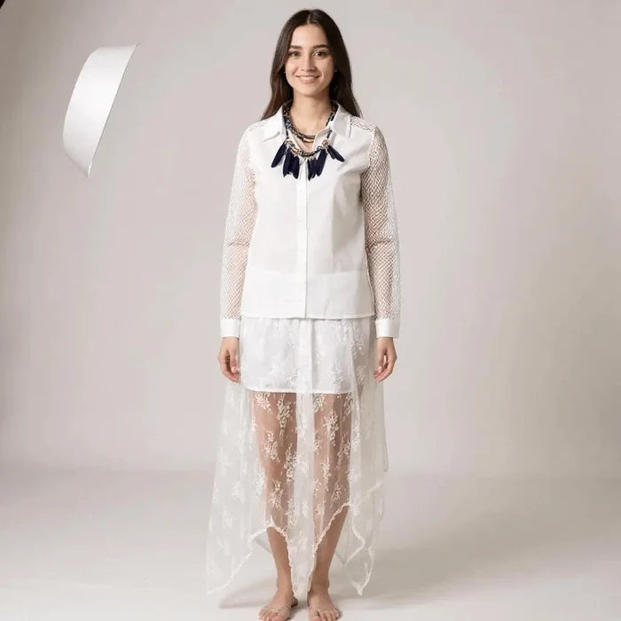 woman wearing white outfit with blue feather necklace White Floral Lace Sheer Asymmetrical Midi Skirt with partial lining, elastic waist, and flowy hanky hem
