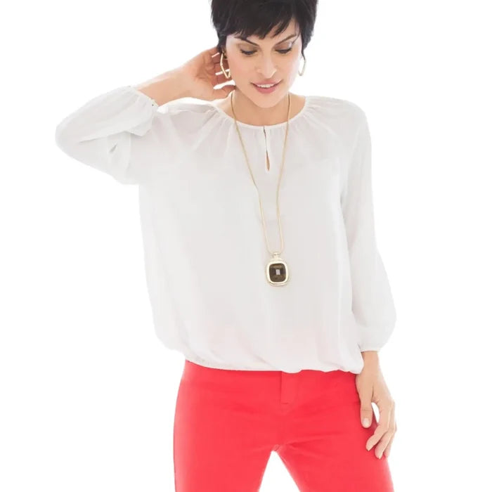 White semi sheer long sleeve blouse with gathered round neckline keyhole button closure and shirred elastic cuffs