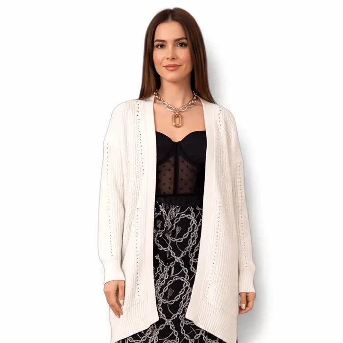 Model wearing a White Oversized Chunky Knit Cardigan styled with a black top and patterned skirt.