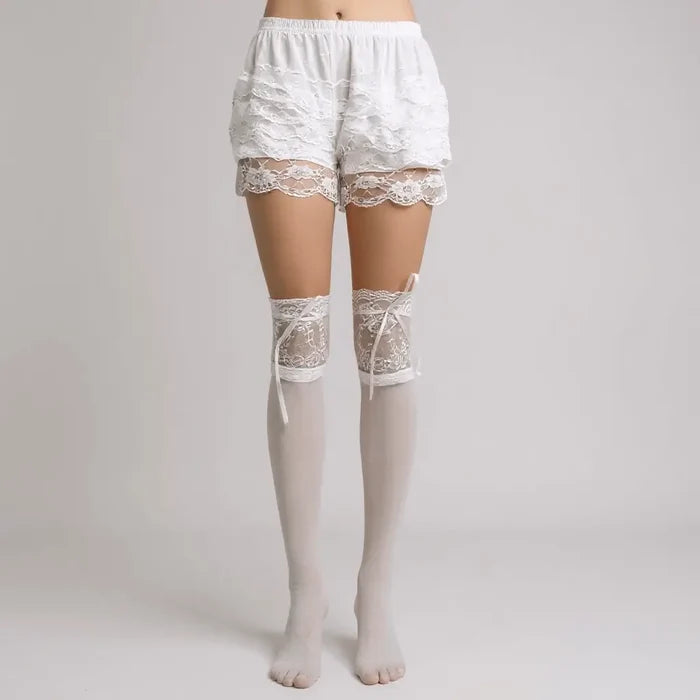 lace-top over-knee white stockings styled with ribbon closure wearing ruffle bloomers