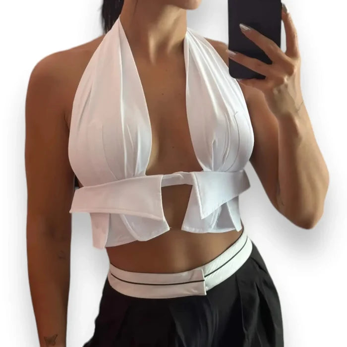 White sleeveless wrap around halter crop top with backless design, tie-back neckline, and cut-out front, styled for Y2K summer festival and beach fashion.
