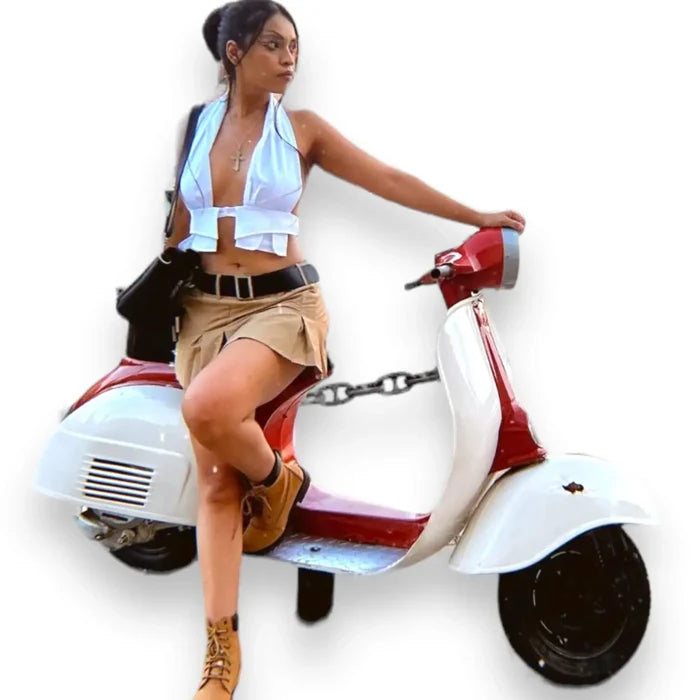 White sleeveless wrap around halter crop top with backless design, tie-back neckline, and cut-out front, styled for Y2K summer festival and beach fashion.
