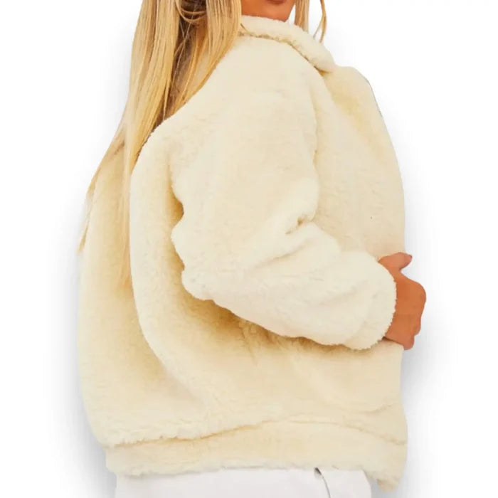 Back view of ivory sherpa teddy winter coat being worn by woman with white background