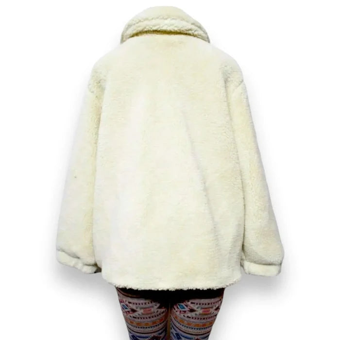 Back view of ivory sherpa teddy jacket layered with leggings