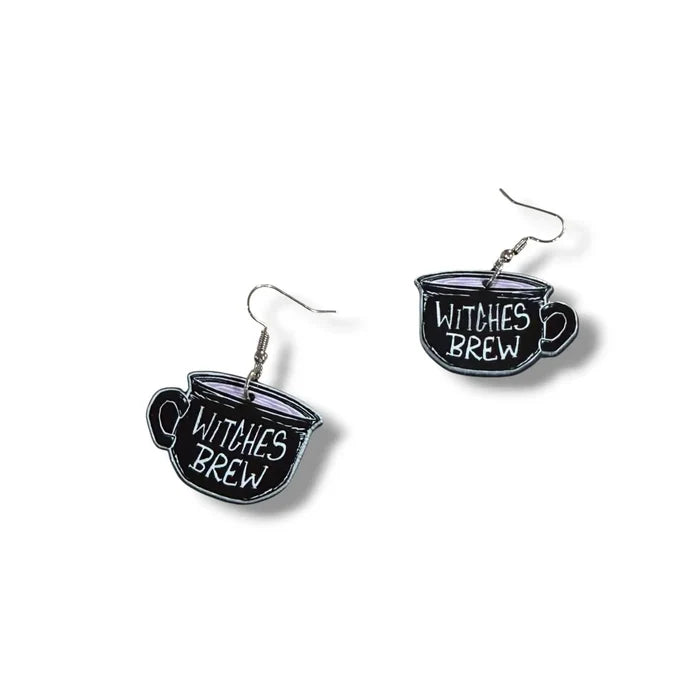 Witches Brew Acrylic Tea Cup Earrings in black with double-sided pink and white lettering and fish hook dangles flat lay