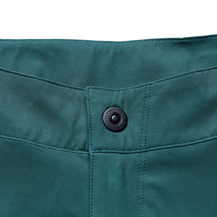 Close-up of a teal fabric with a button on a white background
